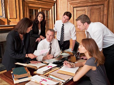 formal conference room with 6 business people, 3 women and 3 men, in discussion